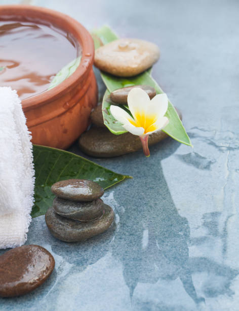 istock Flower and spa set for massage treatment on blue background. 1046889262
