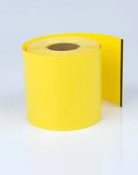 Yellow synthetic thermal paperroll, used for outdooruse, like parking-tickets, etc.