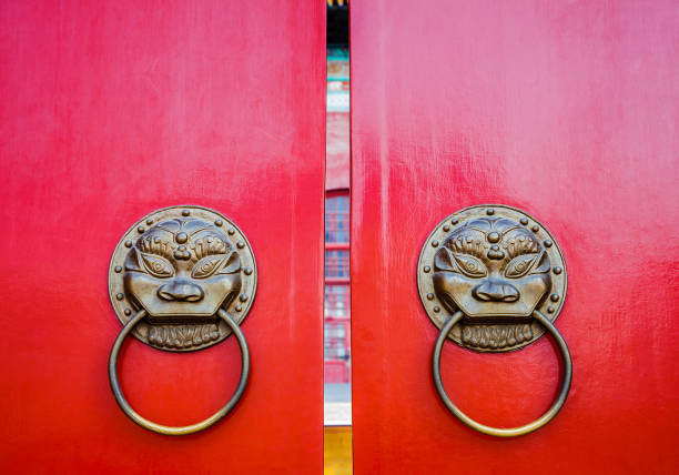 The traditional vermilion wooden door of the temple
