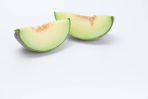 Sliced green cantaloupe melon isolated on white background