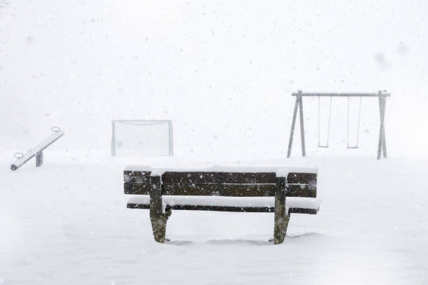istock Playground and bench covered by snow 1046902044