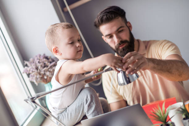 istock Father playing with son at home office 1046917390