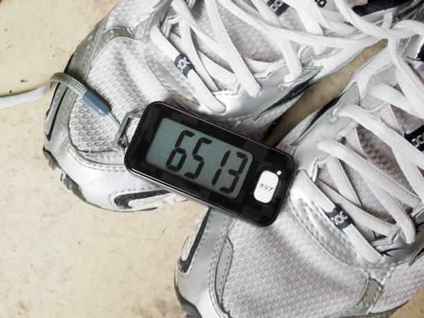 Sneakers and pedometer This is sneakers and a pedometer. pedometer stock pictures, royalty-free photos & images