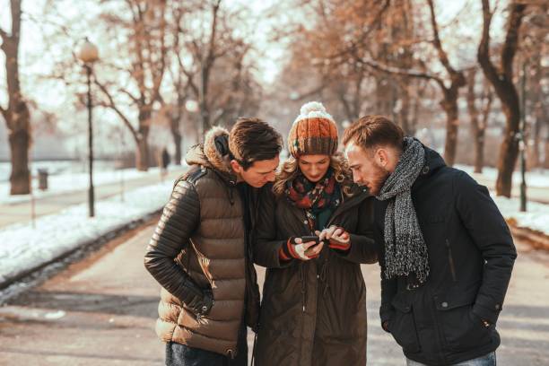 istock Friends having fun looking at smart phone 1046928704