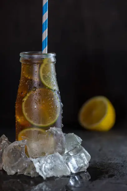 Photo of homemade lemonade ice tea with lemon and ice