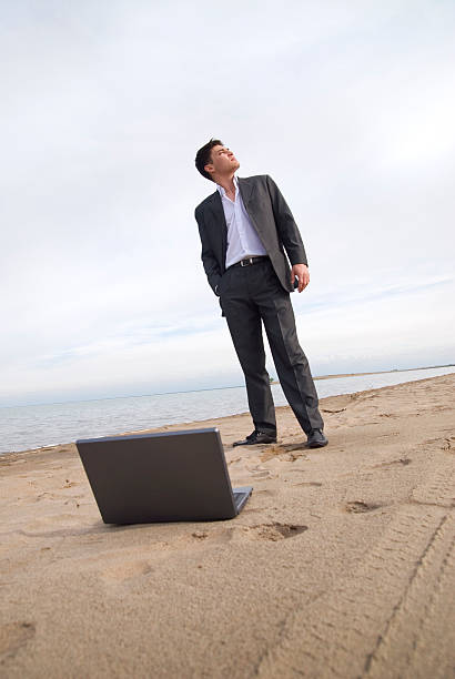 istock guy in a suit on the beach 104693261
