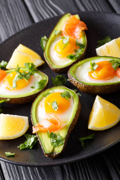istock Organic baked avocado stuffed with egg and salmon closeup. vertical 1046934410