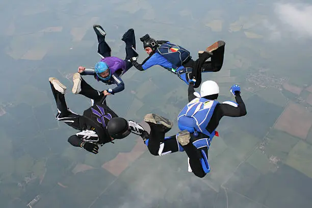 Photo of Four skydivers form a circle