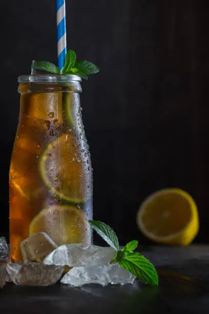 Photo of homemade lemonade ice tea with lemon and ice