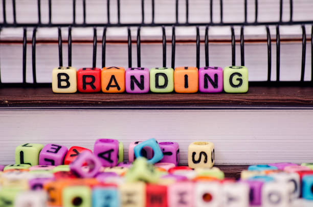 istock Business strategy and marketing concept, cube dices with word BRANDING on note book. Selective focus and shallow depth of field 1046938152