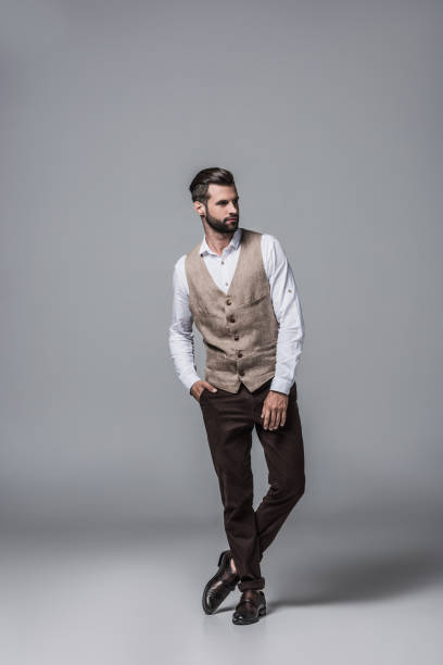 istock handsome bearded man posing in elegant stylish waistcoat on grey 1046940992