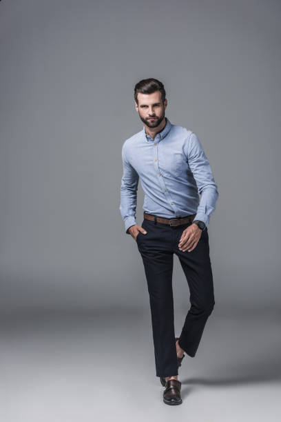 istock handsome stylish businessman posing on grey 1046941036
