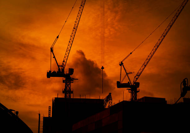 Construction crane silhouette  in blue sky at sunset, Bangkok Thailand.