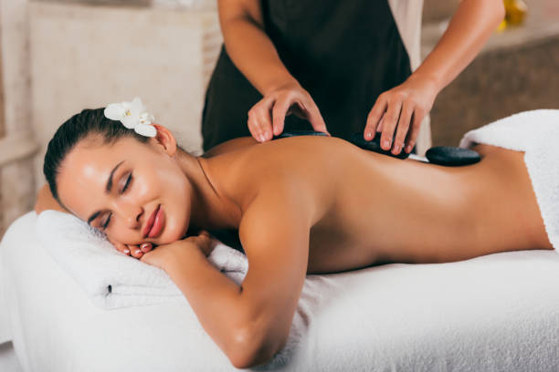 istock young woman having stone therapy at spa center 1046944196