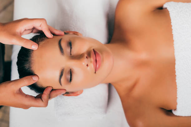 istock smiling woman relaxing in massage salon 1046944252