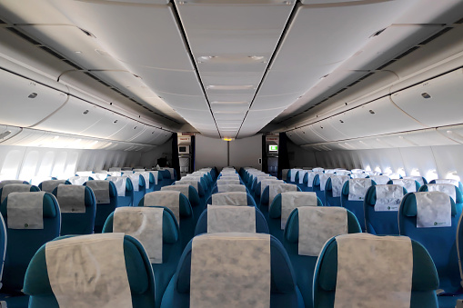In Flight - September 22 2018: Row of empty seats in a Boeing 777-200 of Turkmenistan Airlines.