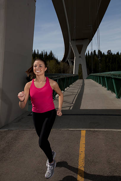 Young Woman Jogging on Path stock photo
