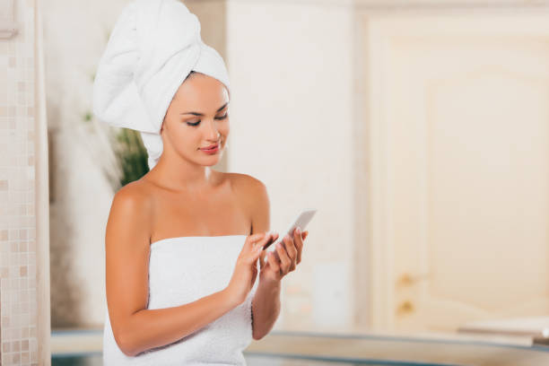 istock attractive woman using gadget at spa salon 1046948930