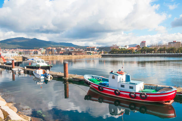 A Coruña, Spain, April 14, 2025: General view of the seaport of the city of A Coruña, Galicia, with the city buildings in the background.