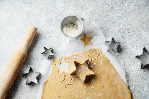 istock Cooking swedish ginger cookies in a star shape, cutting. Flatlay, overhead composition. Christmas atmosphere 1046961502