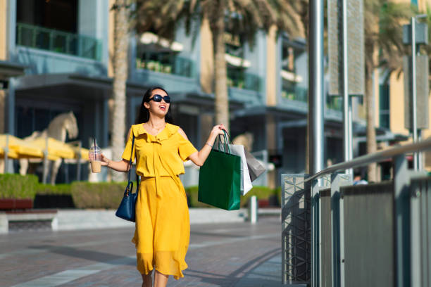 Asian girl with shopping bags and coffee to go Asian girl with shopping bags and coffee to go outdoors arabian sunglasses stock pictures, royalty-free photos & images