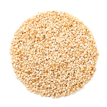 Sesame seeds in circle isolated on white