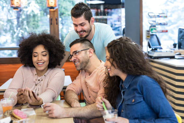 istock Young people enjoying time together in cafe 1046968550