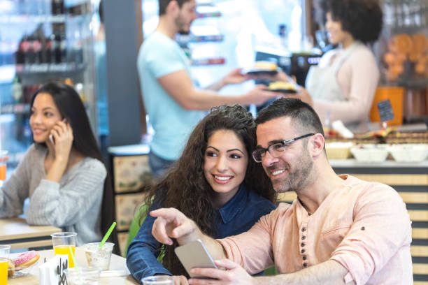 istock Couple in love taking selfie in cafe 1046968556