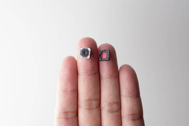 istock Small Digital camera lens and CCD on finger 1046973910