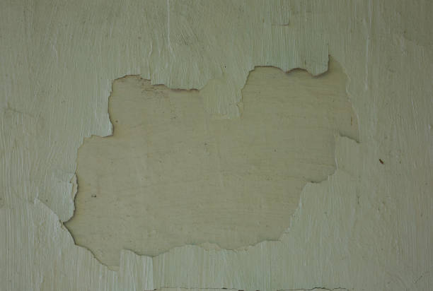istock Whitewash painted wall. Old background with holes and scratches in it. 1046974500