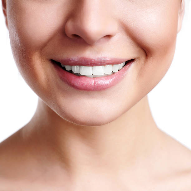 istock A woman showing her pearly white teeth 104697694