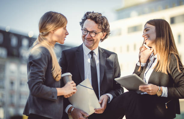 istock Business People Discussing in Front of Building 1046982774