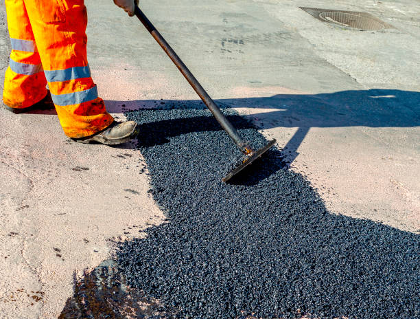 istock worker leveling fresh asphalt during asphalt pavement repair or construction works 1046982846