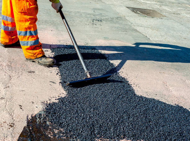istock worker leveling fresh asphalt during asphalt pavement repair or construction works 1046982850