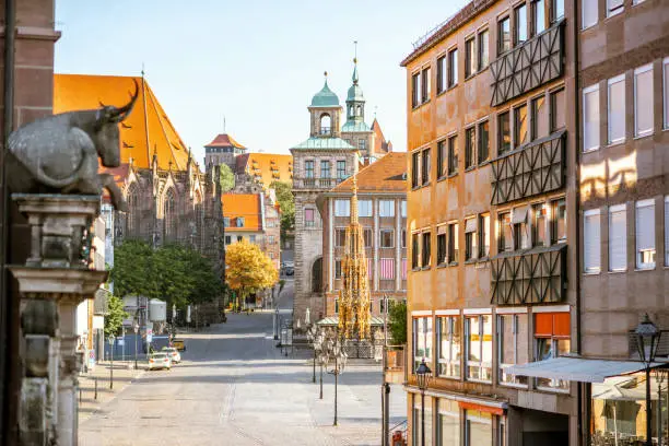 Morning street view on the market square with castle hill on the background in Nurnberg, Germany