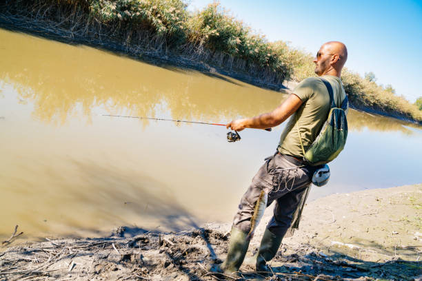 istock Spin fishing on a river with rod 1046983090
