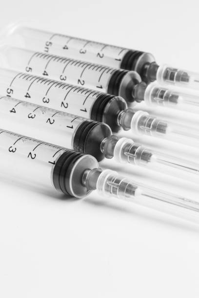 istock Disposable syringe in the row 1046983116