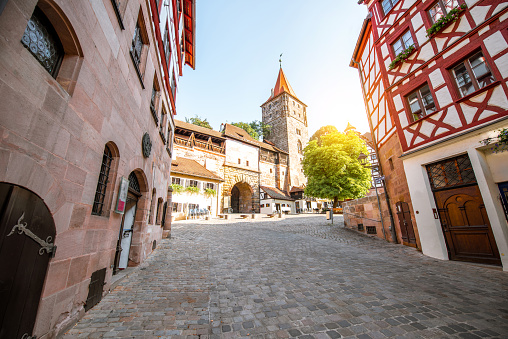 Morning street view with half-timbered houses and castle wall in Nurnberg, Germany