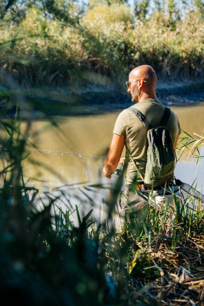 istock Spin fishing on a river with rod 1046983366