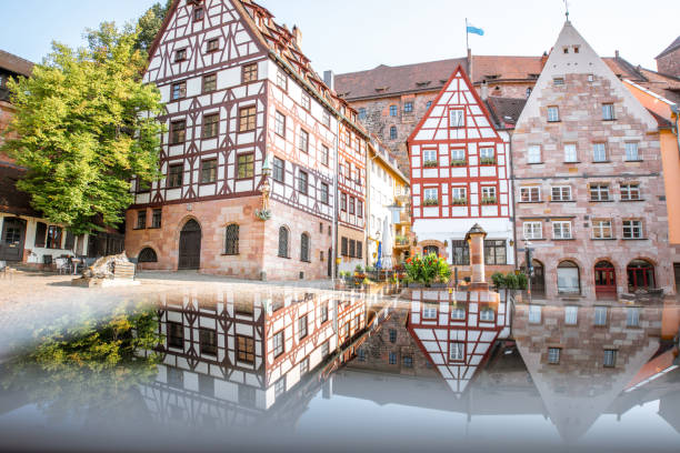 Morning view on the beautiful half-timbered houses with reflection in the old town of Nurnberg, Germany