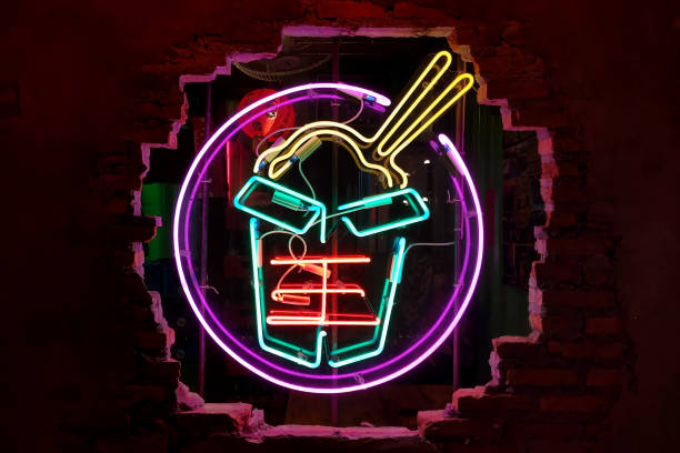 Close-up on a neon shaped into a take out Chinese food.