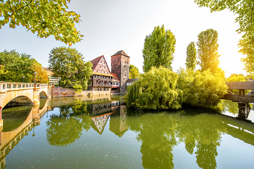 Beautiful landscape view on the riverside with old tower, house in Nurnberg during the sunrise, Germany