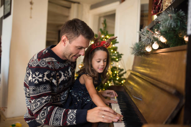 istock Young man playing piano with his daughter 1046986304