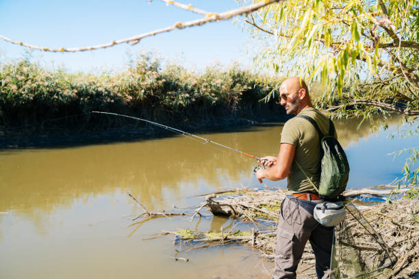 istock Spin fishing on a river with rod 1046986516