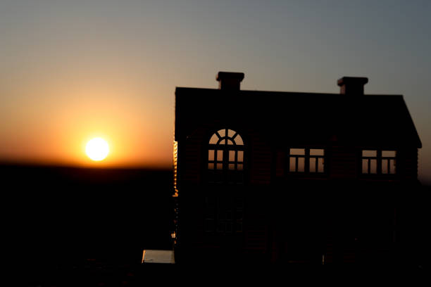 decorative small wooden house on the sunset background. Selective focus