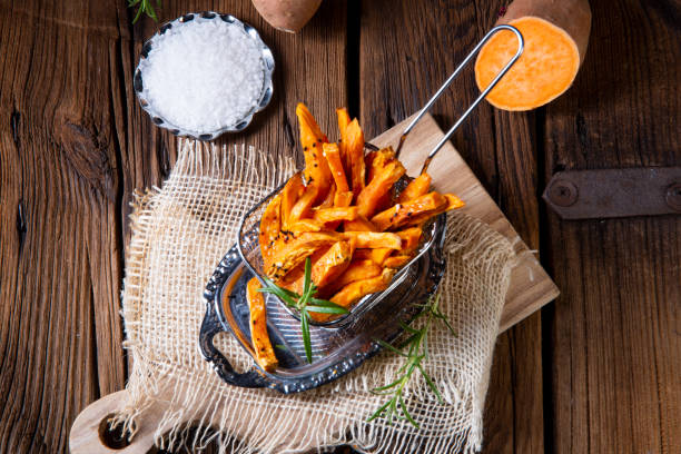 crispy sweet potato fries from the oven crispy sweet potato fries from the ovencrispy sweet potato fries from the oven sweet potato french fries stock pictures, royalty-free photos & images