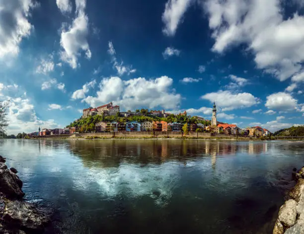Burghausen, Bavaria, Germany: 180 degree panorama of the old town of Burghausen. View from Austria over the border river Salzach in late summertime.