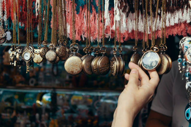 Pocket watch in a woman's hand. Street souvenir shop