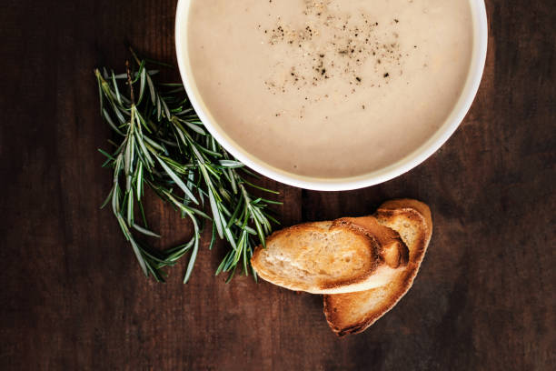 istock Creamy Mushroom Soup in a white bowl on rustic  wooden  table. . Top view. Copy space