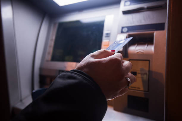 Close up of teenager girl whit cart at ATM.